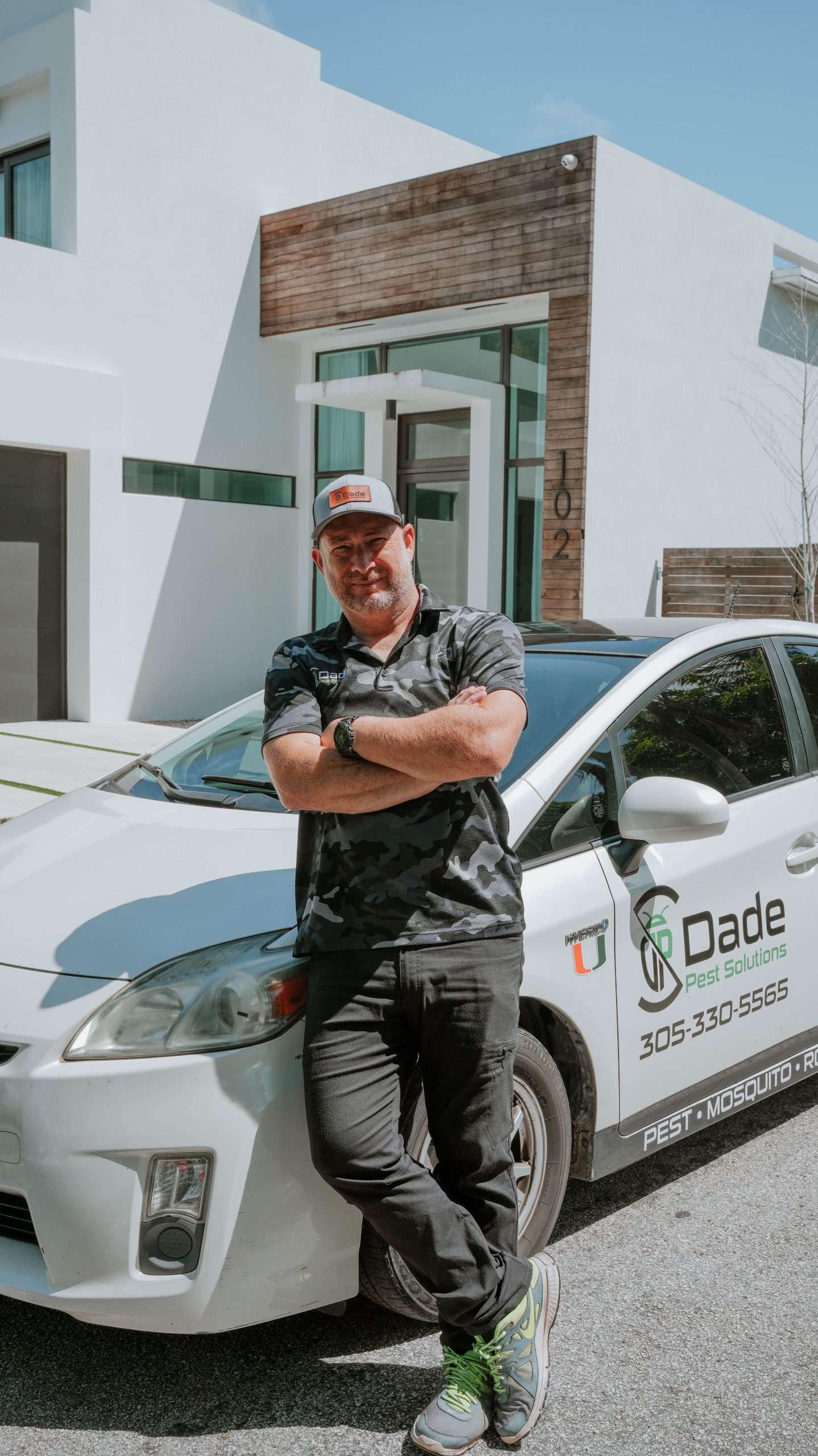Shaun Judy standing beside a Dade Pest Solutions service vehicle in South Florida.